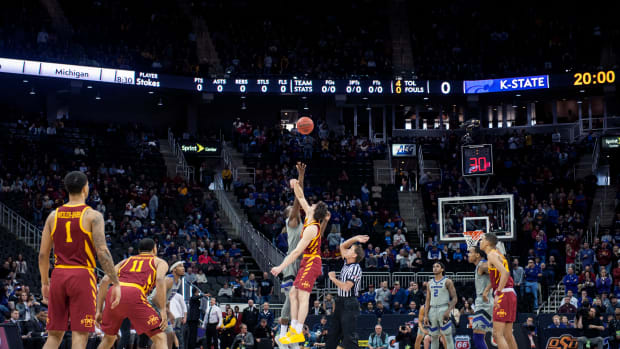 Mar 15, 2019; Kansas City, MO, USA; Kansas State Wildcats forward Makol Mawien (14) and Iowa State Cyclones forward Michael Jacobson (12) tip-off during the first half of the semifinals of the Big 12 conference tournament at Sprint Center. Mandatory Credit: Amy Kontras-USA TODAY Sports